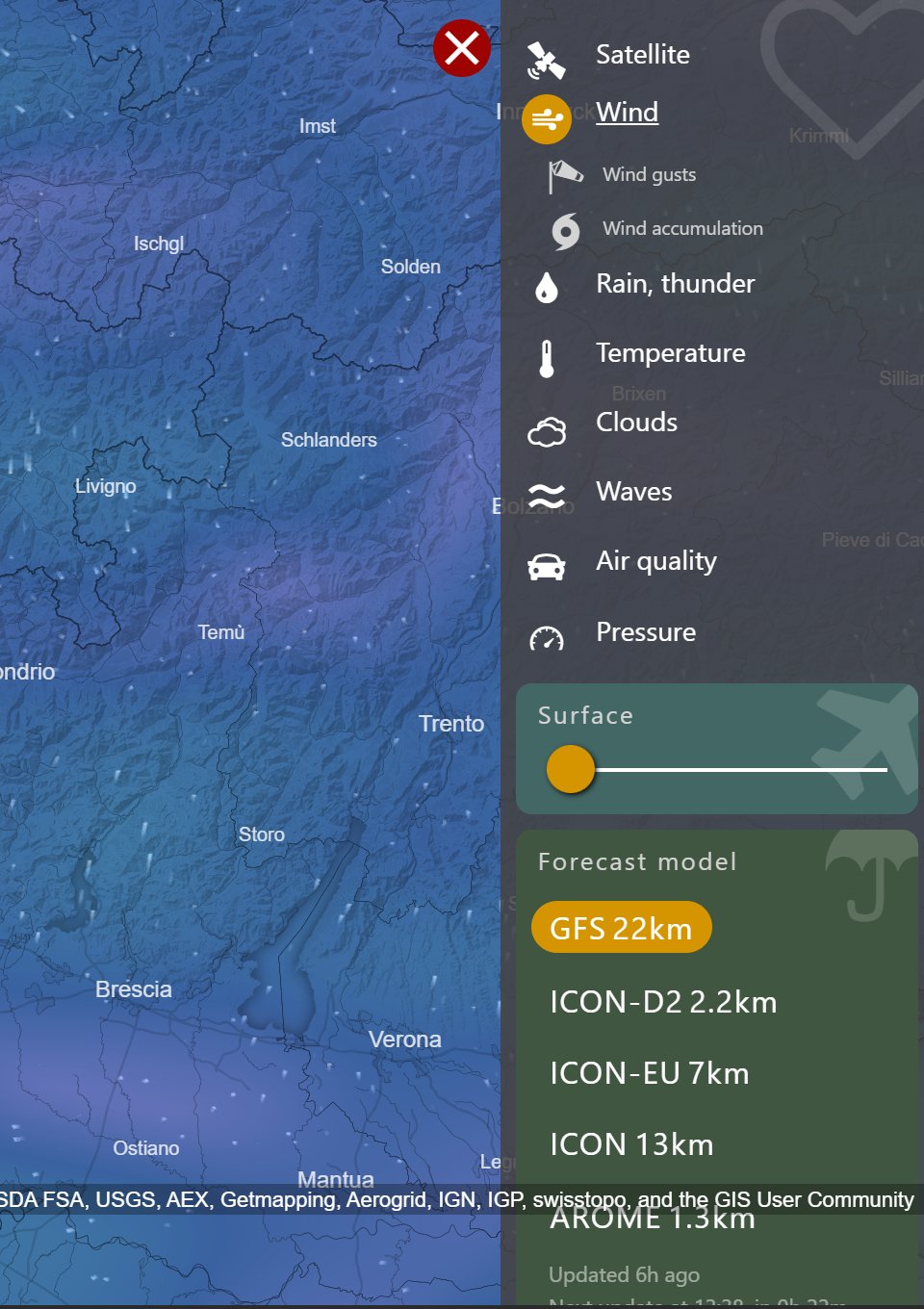 The Windy tab with the Change Layer menu open down the right-hand side, listing Satellite, Wind, Wind gusts, Wind accumulation, Rain, thunder, Temperature, Clouds, Waves, Air quality and Pressure, with an altitude slider and forecast model choices below.
